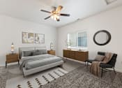 Thumbnail 5 of 61 - A bedroom with a bed, chair, and a rug. at Verraso Village Apartments, Meridian 83646