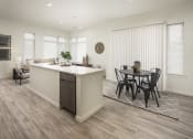 Thumbnail 10 of 26 - an open kitchen and living room with a dining room table and chairs