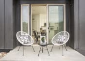 Thumbnail 15 of 26 - a patio with two chairs and a table and a sliding glass door