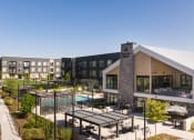 Thumbnail 25 of 26 - a rendering of a building with a pool and patio area with tables