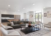 Thumbnail 5 of 29 - A modern living room with a grey sofa, a black coffee table, and a grey armchair.