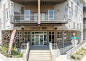 Thumbnail 2 of 29 - The Copestone building has a red banner on the front.