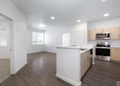 Thumbnail 23 of 29 - A kitchen with white appliances and wooden cabinets.