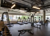 Thumbnail 13 of 28 - a gym with treadmills and other exercise equipment in a building with windows at Crosshatch, Garden City, ID, 83714