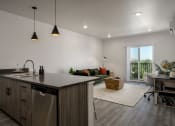 Thumbnail 3 of 28 - an open kitchen and living room in a home with white walls and wood floors at Crosshatch, Garden City