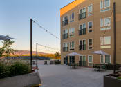 Thumbnail 2 of 28 - an outdoor patio with tables and umbrellas in front of a building at Crosshatch, Garden City, 83714