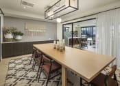 Thumbnail 3 of 26 - a dining room with a wooden table and chairs