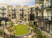 Thumbnail 6 of 67 - a rendering of an apartment building with a miniature golf course at Cycle Apartments, Fort Collins, 80525