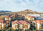 Thumbnail 25 of 28 - A large housing development with a mountain in the background.