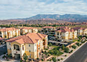 Thumbnail 24 of 28 - A row of houses with a mountain in the background.