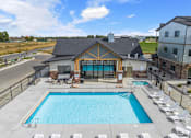 Thumbnail 1 of 45 - A large outdoor swimming pool with lounge chairs at The Expo in Billings, MT,