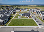 Thumbnail 52 of 64 - A large grassy area in front of apartment buildings. at Silverbrook Apartments, Kalispell, Montana