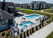 Thumbnail 46 of 64 - A swimming pool surrounded by a black fence and a grassy area. at Silverbrook Apartments, Kalispell, Montana