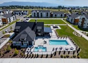 Thumbnail 42 of 64 - A large house with a pool in the foreground and several smaller houses in the background. at Silverbrook Apartments, Kalispell, MT, 59901