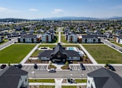 Thumbnail 54 of 64 - A large building with a pool in the middle of a parking lot. at Silverbrook Apartments, Montana