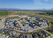 Thumbnail 49 of 64 - A bird's eye view of a residential area with houses and a parking lot. at Silverbrook Apartments, Kalispell, MT, 59901