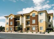 Thumbnail 21 of 28 - A row of apartment buildings with balconies and stone pillars.