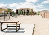 Thumbnail 6 of 28 - A playground with a bench and a basketball hoop.