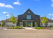Thumbnail 43 of 64 - A modern building with a dark grey exterior and a large glass entrance at Silverbrook Apartments, Kalispell, Montana 59901