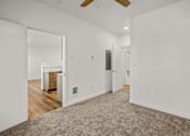 Thumbnail 27 of 64 - A room with a carpeted floor and a ceiling fan at Silverbrook Apartments, Montana
