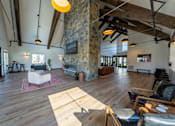 Thumbnail 30 of 64 - A living room with a stone pillar and wooden floors. at Silverbrook Apartments, Kalispell, MT