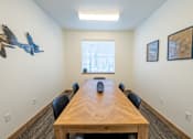 Thumbnail 36 of 64 - A conference room with a long table and chairs. at Silverbrook Apartments, Kalispell, Montana