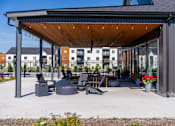 Thumbnail 61 of 64 - A patio area with a fire pit and seating area. at Silverbrook Apartments, Kalispell 59901