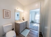 Thumbnail 18 of 64 - A bathroom with a toilet, sink, and mirror. at Silverbrook Apartments, Kalispell, MT