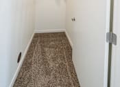 Thumbnail 12 of 64 - A hallway with a brown carpet and a white wall. at Silverbrook Apartments, Kalispell 59901