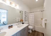 Thumbnail 13 of 64 - A white bathroom with a toilet, sink, and shower. at Silverbrook Apartments, Kalispell