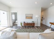 Thumbnail 2 of 64 - A living room with a white couch and a painting on the wall. at Silverbrook Apartments, Kalispell, Montana