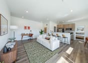 Thumbnail 1 of 64 - A living room with a white couch and a green rug. at Silverbrook Apartments, Kalispell, MT, 59901