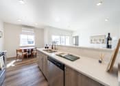 Thumbnail 8 of 64 - A modern kitchen with a large island and stainless steel appliances. at Silverbrook Apartments, Kalispell