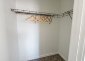 Thumbnail 16 of 64 - A white wall with a metal rack and hangers. at Silverbrook Apartments, Montana
