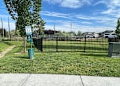 Thumbnail 16 of 28 - a park with a fence and a sign in the grass