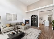 Thumbnail 3 of 61 - A modern living room with a fireplace and a grey sofa. at Verraso Village Apartments, Meridian, ID