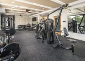 Thumbnail 1 of 26 - a gym with weights and other exercise equipment on the floor