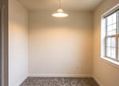 Thumbnail 2 of 3 - A room with a carpeted floor and a window.