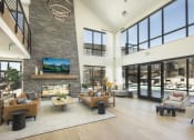 Thumbnail 2 of 26 - a living room with couches and chairs and a large stone fireplace