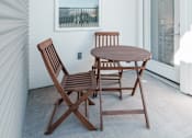 Thumbnail 18 of 31 - A patio with a table and two chairs.
