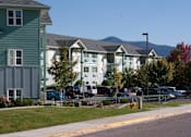 Thumbnail 6 of 46 - A row of houses with cars parked in front at Great Northern, Missoula, MT