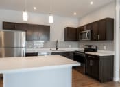 Thumbnail 33 of 45 - Kitchen with cabinets at The Expo Apartments, Billings