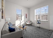 Thumbnail 8 of 29 - A living room with a grey couch and window at Spruce Street, Missoula