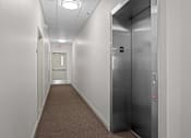 Thumbnail 28 of 29 - A long hallway with a stainless steel elevator at Spruce Street, Montana, 59802