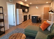 Thumbnail 3 of 33 - Open-concept 1-3 bedroom interior at Morrow Apartments in St. Paul, MN with a kitchen island and modern finishes.