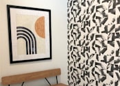 Thumbnail 12 of 33 - A picture of a framed artwork is hanging on a wall.