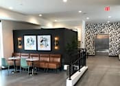 Thumbnail 16 of 33 - Modern lobby and elevator at Morrow Apartments in St. Paul, MN, with designer seating and contemporary finishes.
