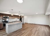 Thumbnail 25 of 51 - A modern kitchen with wooden floors and a large island.