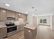 Thumbnail 10 of 40 - A kitchen with wooden cabinets and granite countertops.