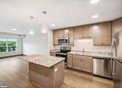 Thumbnail 13 of 40 - A kitchen with wooden cabinets and a granite countertop.